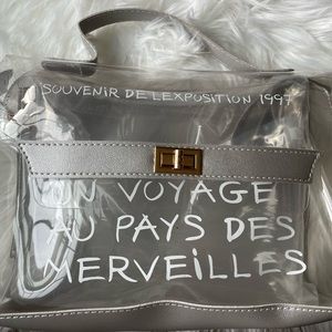 NWT ‘Un Voyage Aux Pays Des Merveilleuses’ clear bag